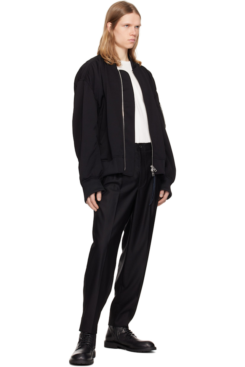 Plain-woven wool trousers. 

· D-rings at belt loops
· Detachable logo-printed leather strap at belt loop
· Four-pocket styling
· Zip fly
· Pleats at front 
· Creased legs
· Jacquard logo pattern at back 
· Partially lined

Supplier color: Black