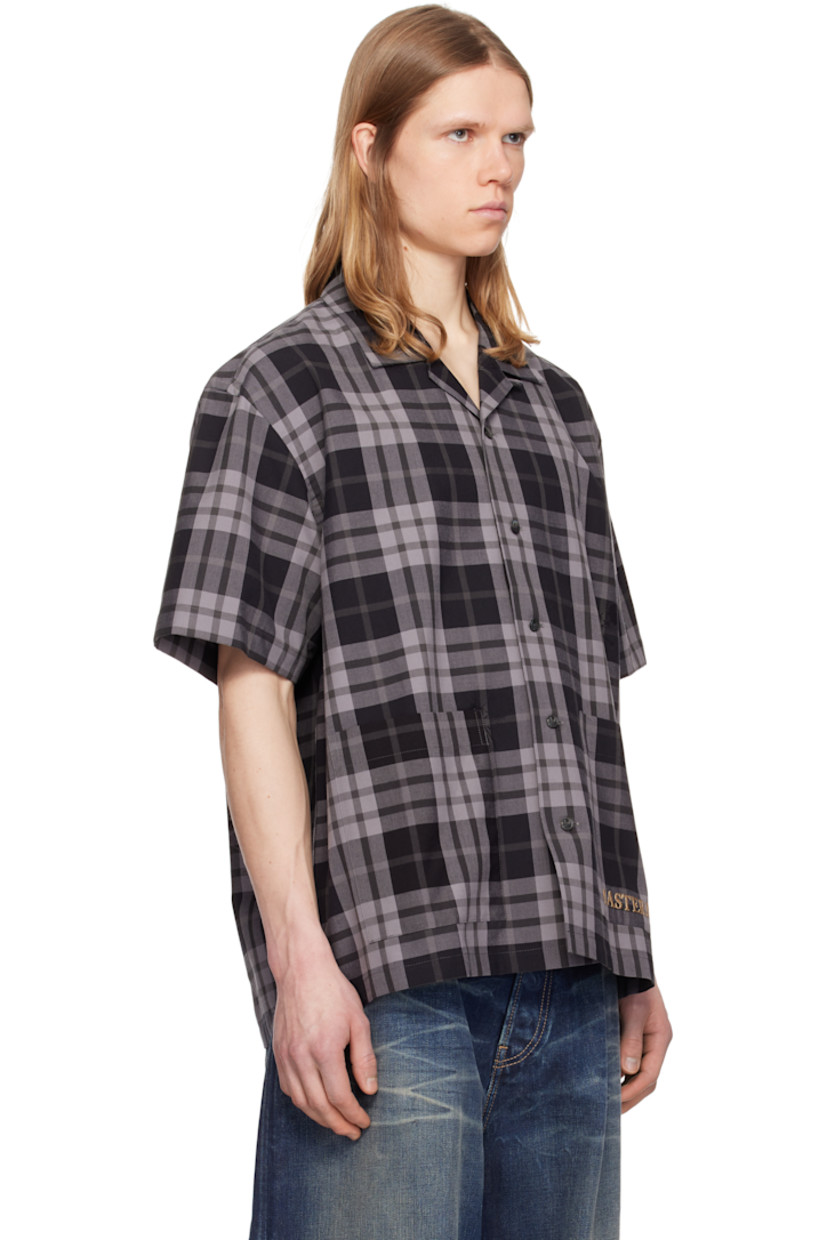 Plain-woven cotton shirt. Check pattern and jacquard logo graphics throughout. 

· Open spread collar
· Button closure 
· Patch pockets
· Logo embroidered at hem
· Vented side seams
· Logo graphic embroidered at back
· Twin pleats at back yoke
· Detachable logo-printed trim at interior
· Logo-engraved hardware

Supplier color: Black