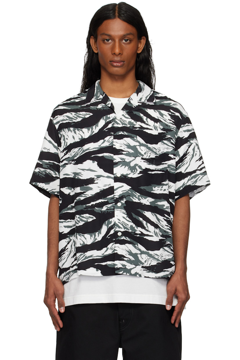Plain-woven rayon shirt. Graphic camouflage pattern printed throughout. 

· Open spread collar
· Button closure 
· Patch pocket at chest
· Dropped shoulders
· Twin pleats at back yoke

Supplier color: Black/White