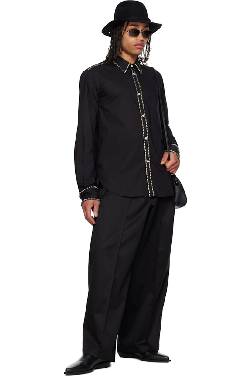 Cotton poplin shirt. Studded detailing throughout. 

· Spread collar
· Button closure
· Patch pocket 
· Shirttail hem
· Single-button barrel cuffs
· Box pleat at back yoke
· Logo-engraved mother-of-pearl hardware

Supplier color: Black