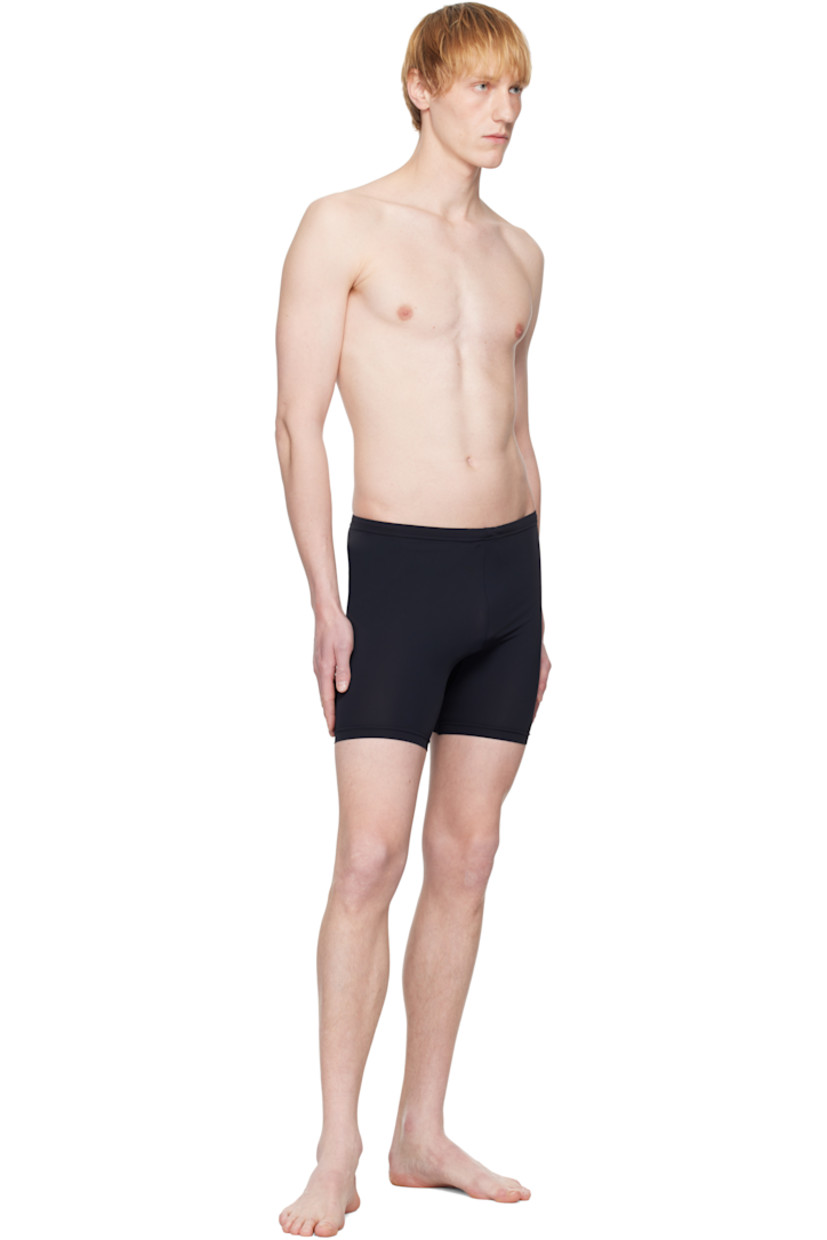 Stretch nylon jersey swim shorts. 

· Concealed drawstring at elasticized waistband
· Gusset at inseams
· White stitching at back

Supplier color: Black