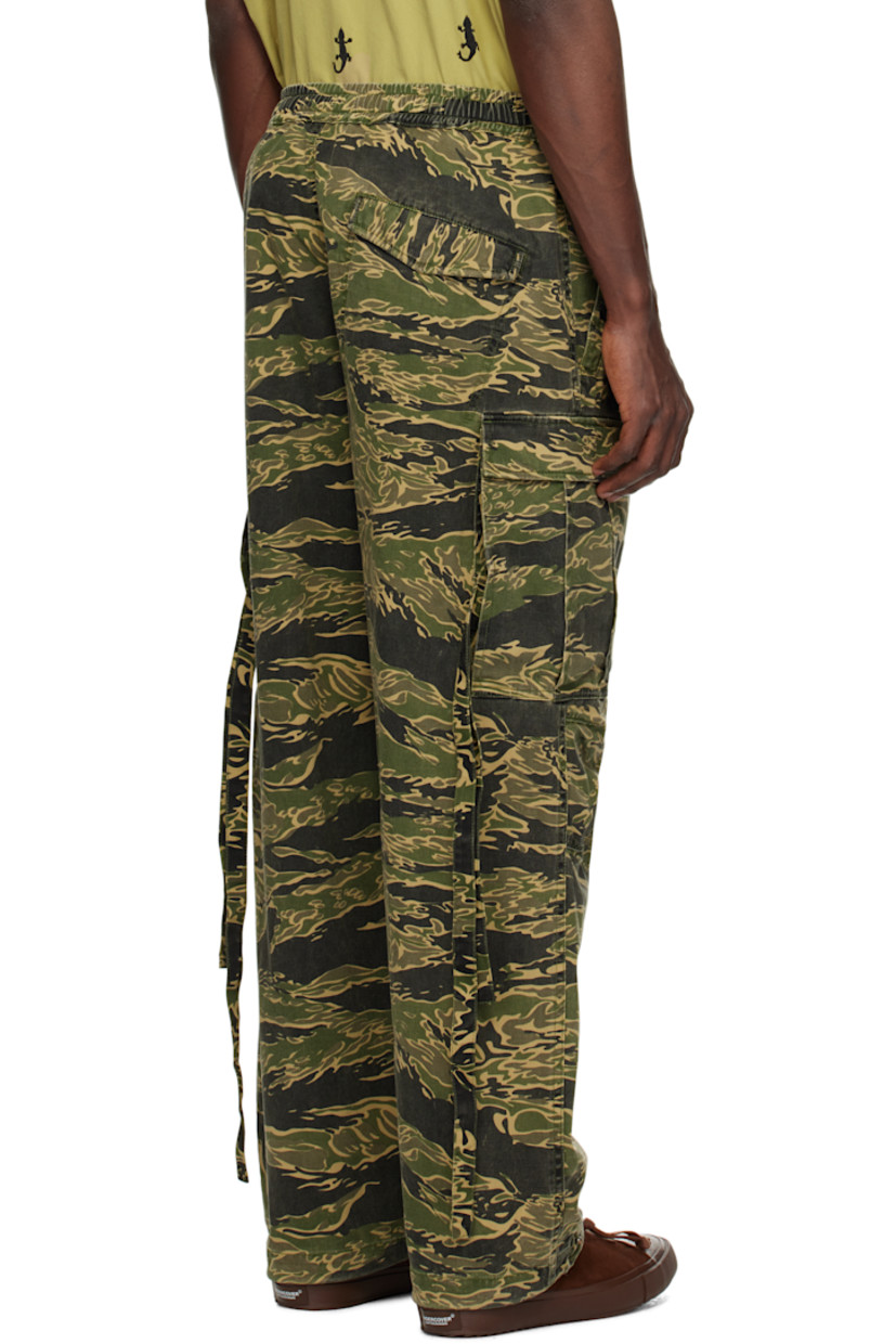280 gsm cotton- and hemp-blend twill cargo pants. Camouflage pattern printed throughout.

· Loose-fit and tapered
· Offset drawstring at elasticized waistband
· Four-pocket styling
· Offset mock fly
· Darts at knees
· Bungee-style drawstring at cuffs
· Cargo pocket with straps at outseams

Supplier color: Mint gold