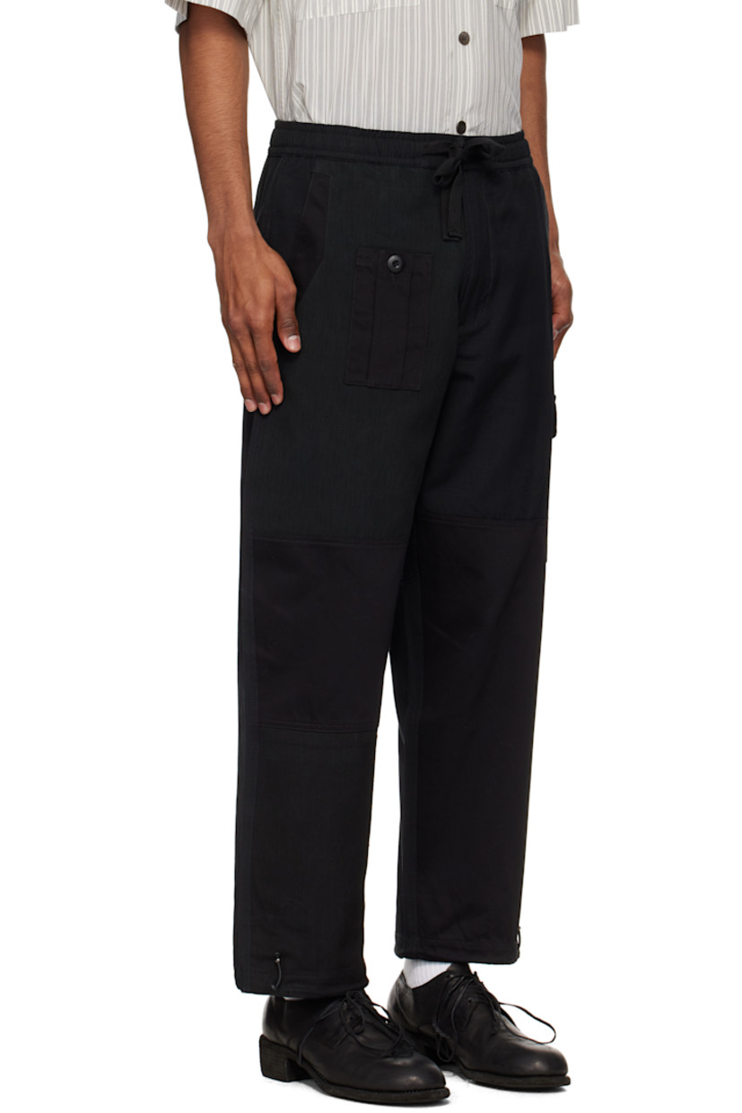Loose-fit upcycled cotton canvas track pants. Twill panels throughout.

· Paneled construction
· Drawstring at elasticized waistband
· Five-pocket styling
· Zip fly
· Bungee-style drawstring at cuffs
· Flap pocket at outseam

Supplier color: Black