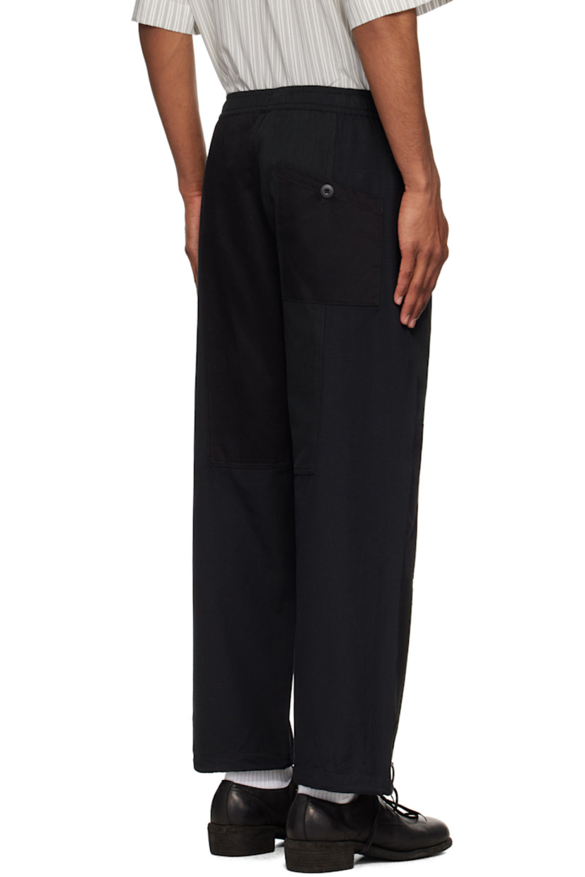 Loose-fit upcycled cotton canvas track pants. Twill panels throughout.

· Paneled construction
· Drawstring at elasticized waistband
· Five-pocket styling
· Zip fly
· Bungee-style drawstring at cuffs
· Flap pocket at outseam

Supplier color: Black