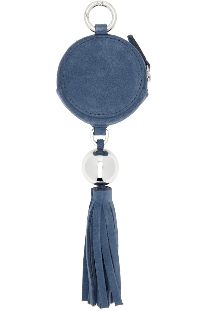 Lambskin suede coin pouch in blue.

· Hinged ring at top
· Logo charm and tassel at drop 
· Zip closure
· H9.5" x W2.5" x 1.5"

Supplier color: Sky blue