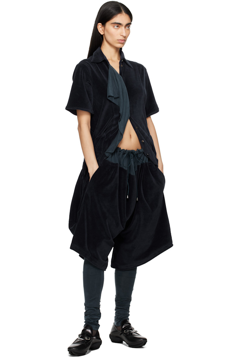 Cotton velour minidress. 

· Paneled construction
· Spread collar
· Concealed button closure
· Draped stretch cupro jersey panel at front
· Patch pockets
· Vented bubble hem 
· Pleats at back waist

Supplier color: Midnight navy/Spruce blue