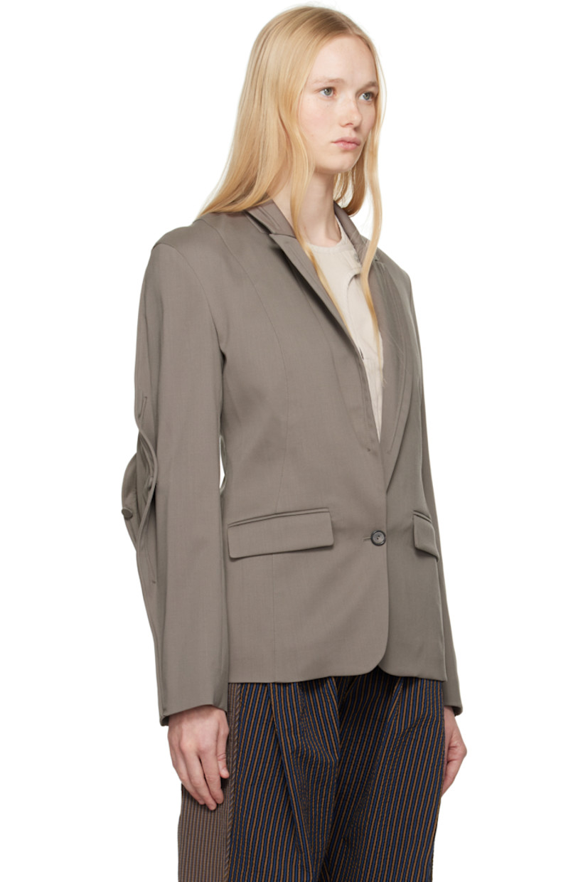 Stretch virgin wool twill blazer.

· Piping at peaked lapel and sleeves
· Button closure
· Flap pockets
· Buttoned expansion panel at sleeves
· Central vent at back hem
· Welt pockets at interior
· Full viscose satin lining

Supplier color: Slate grey