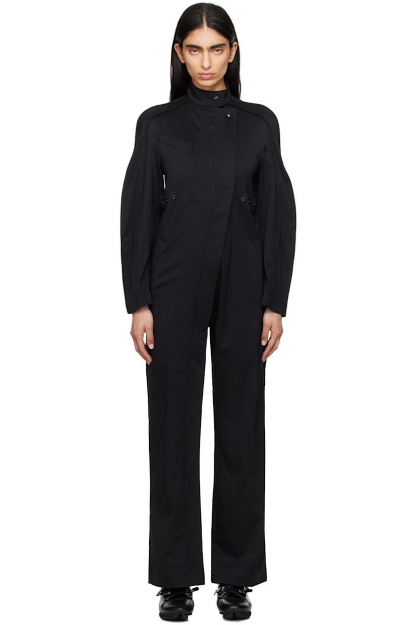 Straight-leg stretch virgin wool twill jumpsuit. Piping throughout.

· Press-stud tab at stand collar 
· Concealed offset two-way zip closure extends to cuff
· Press-stud placket at front 
· Welt pocket at chest
· Adjustable press-stud tabs at waist
· Three-pocket styling
· Pinched seams at saddle shoulders and sleeves
· Darts at back

Supplier color: Night black