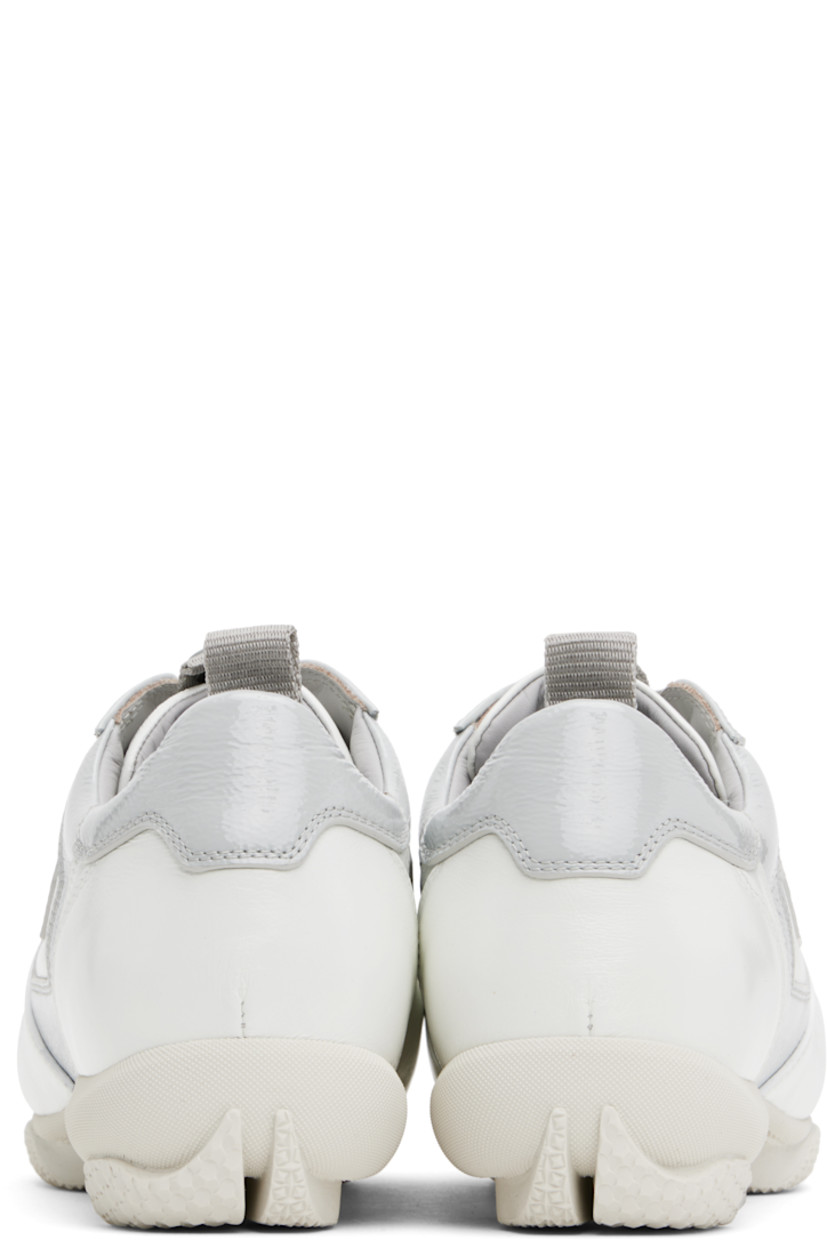 Low-top polished leather and patent calfskin sneakers in white and gray.

· Lace-up closure
· Pull-loop with logo hardware at padded tongue 
· Padded collar
· Pull-loop at heel collar
· Buffed leather and suede lining
· Treaded rubber sole

Supplier color: White brilliant