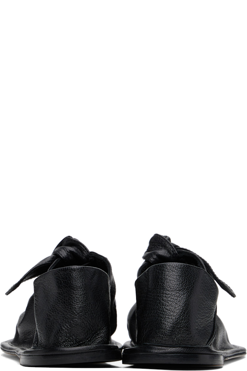Handcrafted grained lambskin ballerina flats in black.

· Square toe
· Knotted detailing at partially elasticized strap
· Collapsible heel counter
· Calfskin sole with rubber injection

Supplier color: Black