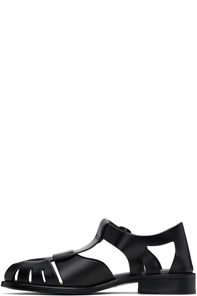 Handcrafted polished calfskin flat sandals in black.

· Cutouts throughout
· Pin-buckle ankle strap
· Logo embossed at padded calfskin footbed
· Suede lining
· Serrated detailing at welt
· Stacked calfskin heel and midsole
· Calfskin sole with rubber injection

Supplier color: Black
