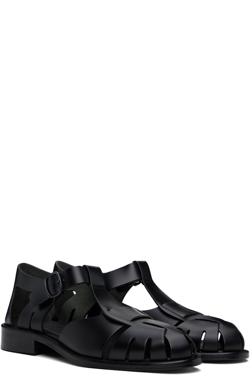 Handcrafted polished calfskin flat sandals in black.

· Cutouts throughout
· Pin-buckle ankle strap
· Logo embossed at padded calfskin footbed
· Suede lining
· Serrated detailing at welt
· Stacked calfskin heel and midsole
· Calfskin sole with rubber injection

Supplier color: Black