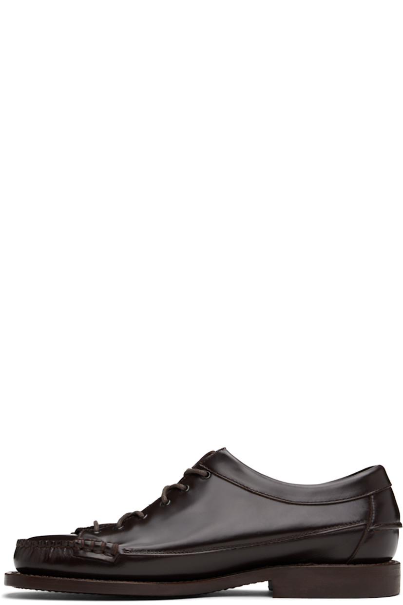 Handcrafted polished calfskin loafers in brown.

· Moc toe
· Lace-up closure
· Pinched seam at heel counter
· Logo-embossed padded leather footbed
· Grained calfskin lining
· Stacked leather heel with rubber injection
· Calfskin sole
· Heel: H1"

Supplier color: Dark brown