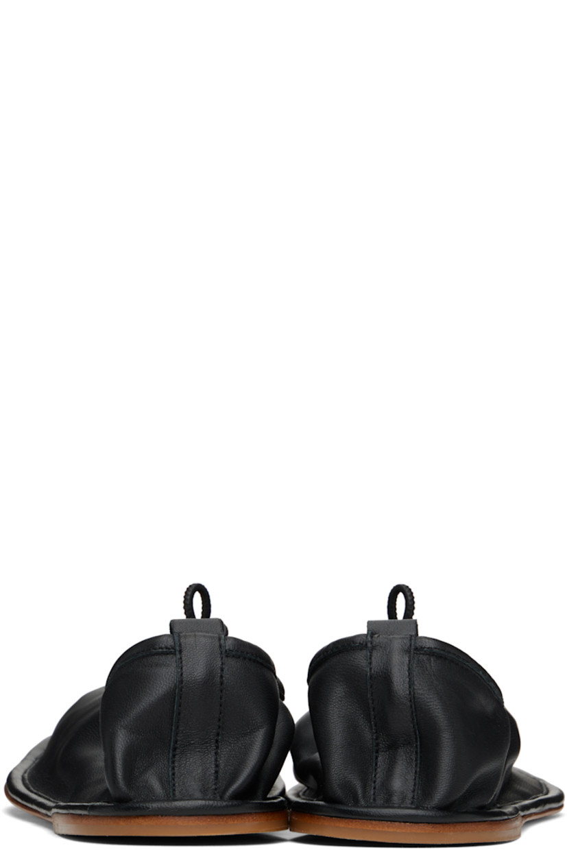 Handcrafted buffed lambskin loafers in black.

· Pleats at square toe
· Drawstring at collar
· Pull-loop at heel collar
· Suede interior
· Leather sole with rubber injection

Supplier color: Black