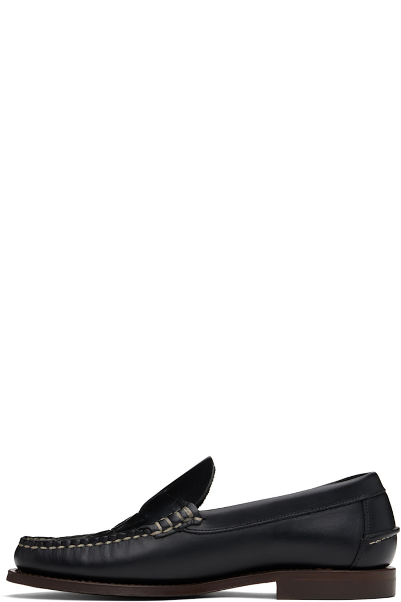 Handcrafted vegetable-tanned calfskin loafers in black.

· Moc toe
· Woven detailing at vamp
· Pinched seam at heel counter
· Logo-embossed padded leather footbed
· Suede lining
· Stacked leather heel with rubber injection
· Calfskin sole
· Contrast stitching in white

Supplier color: Black