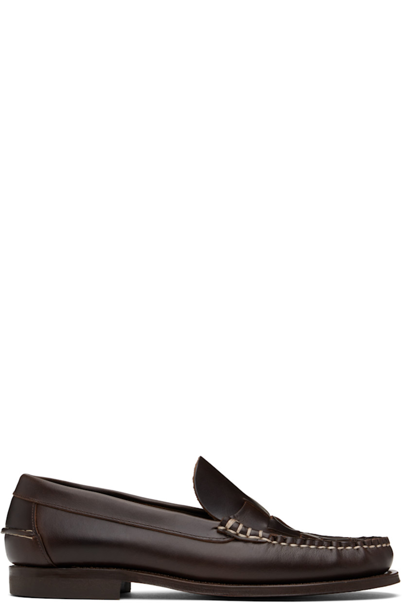 Handcrafted vegetable-tanned calfskin loafers in brown.

· Moc toe
· Woven detailing at vamp
· Pinched seam at heel counter
· Logo-embossed padded leather footbed
· Suede lining
· Stacked leather heel with rubber injection
· Calfskin sole
· Contrast stitching in white

Supplier color: Dark brown