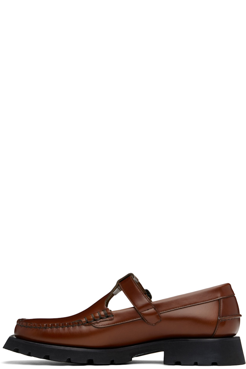 Handcrafted polished calfskin loafers in tan.

· Moc toe
· Pin-buckle strap at vamp
· Pinched seam at heel counter
· Logo-embossed padded leather footbed
· Suede lining
· Rubber block heel
· Treaded rubber sole 
· Contrast stitching in black
· Heel: H1.5"

Supplier color: Tan