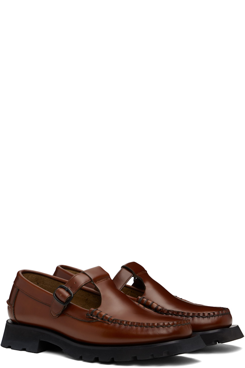 Handcrafted polished calfskin loafers in tan.

· Moc toe
· Pin-buckle strap at vamp
· Pinched seam at heel counter
· Logo-embossed padded leather footbed
· Suede lining
· Rubber block heel
· Treaded rubber sole 
· Contrast stitching in black
· Heel: H1.5"

Supplier color: Tan