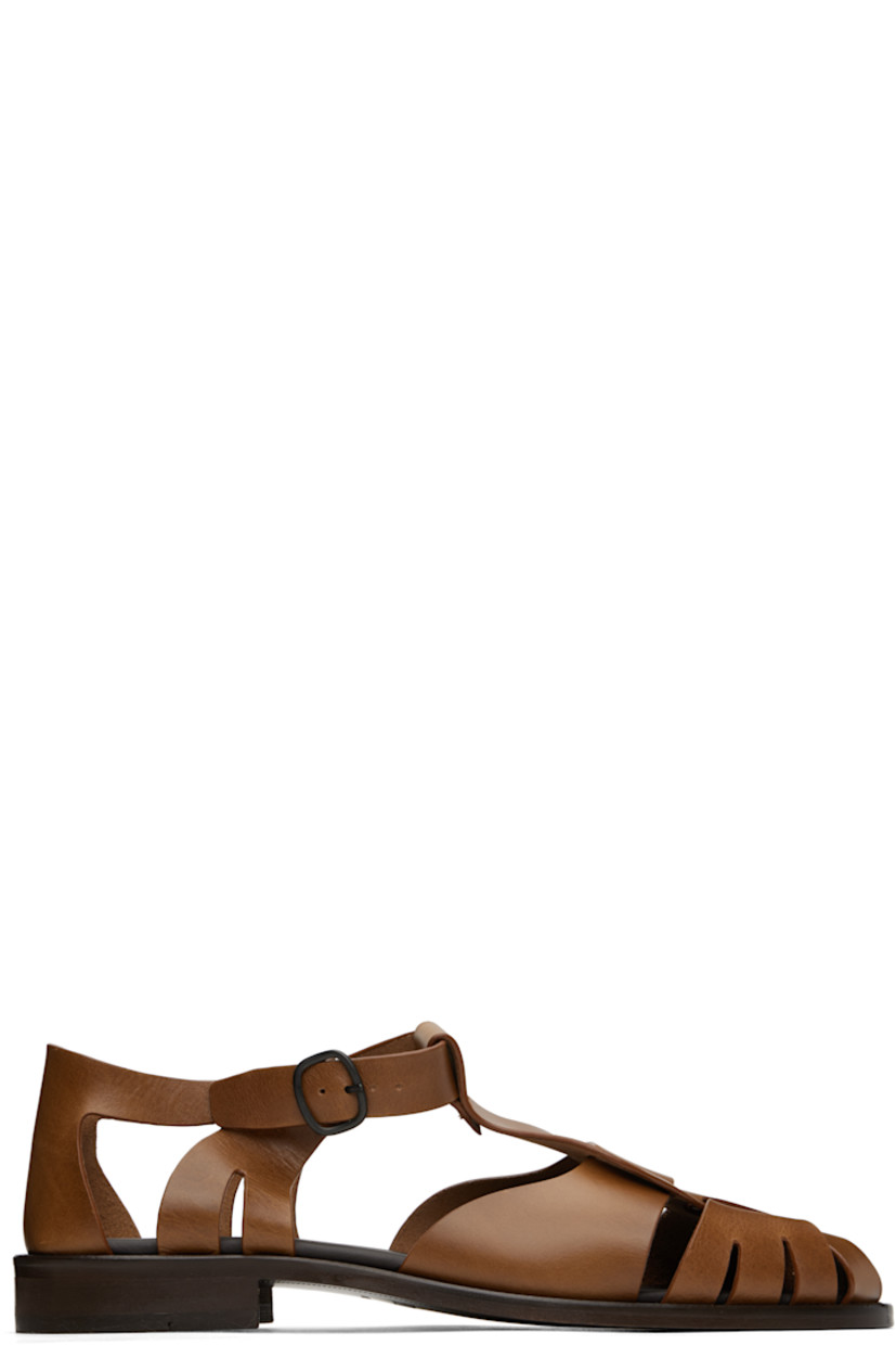 Vegetable-tanned calfskin sandals in brown.

· Cutouts throughout
· Pin-buckle ankle strap
· Logo embossed at padded calfskin footbed
· Stacked leather heel and midsole
· Leather sole with rubber injection
· Heel: H1"

Supplier color: Brown