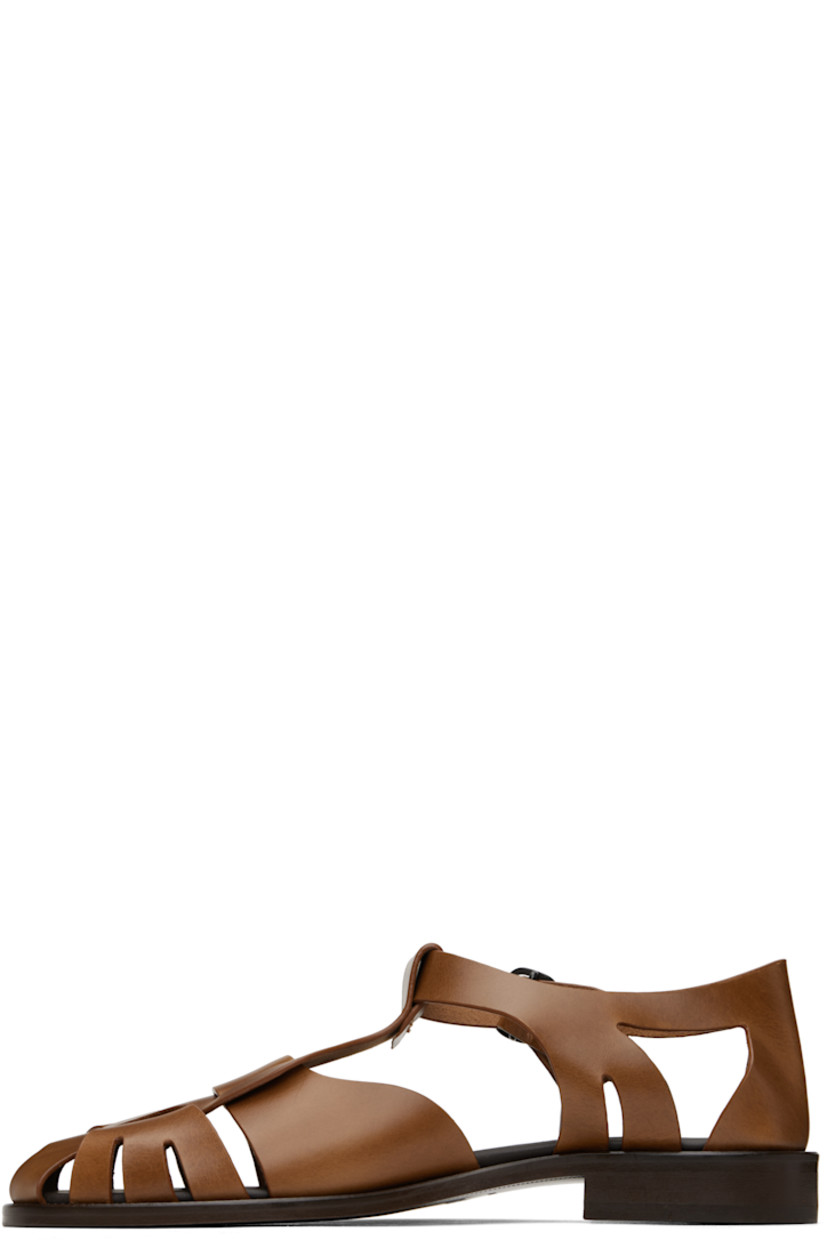 Vegetable-tanned calfskin sandals in brown.

· Cutouts throughout
· Pin-buckle ankle strap
· Logo embossed at padded calfskin footbed
· Stacked leather heel and midsole
· Leather sole with rubber injection
· Heel: H1"

Supplier color: Brown