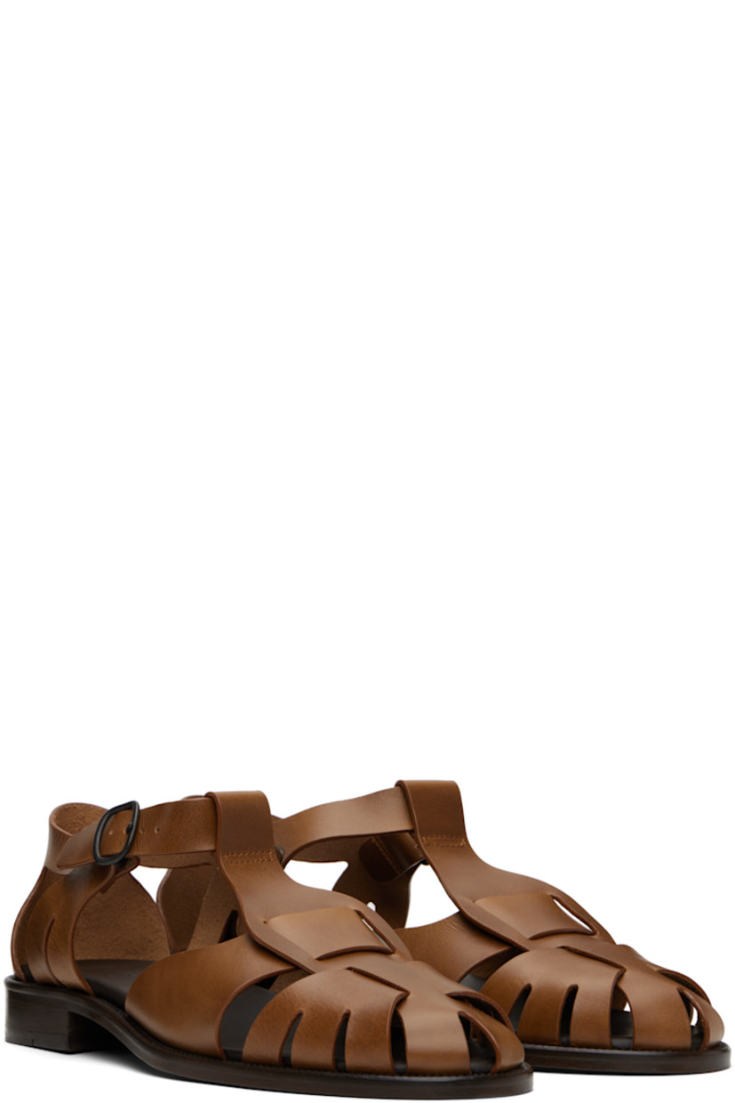 Vegetable-tanned calfskin sandals in brown.

· Cutouts throughout
· Pin-buckle ankle strap
· Logo embossed at padded calfskin footbed
· Stacked leather heel and midsole
· Leather sole with rubber injection
· Heel: H1"

Supplier color: Brown