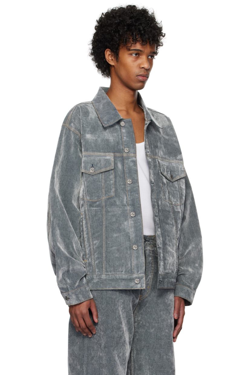 Flocked non-stretch denim jacket. 

· Spread collar 
· Button closure
· Flap pockets
· Welt pockets
· Pleat at single-button barrel cuffs
· Adjustable button tabs and logo patch at back hem
· Contrast stitching in tan 

Supplier color: Grey flock