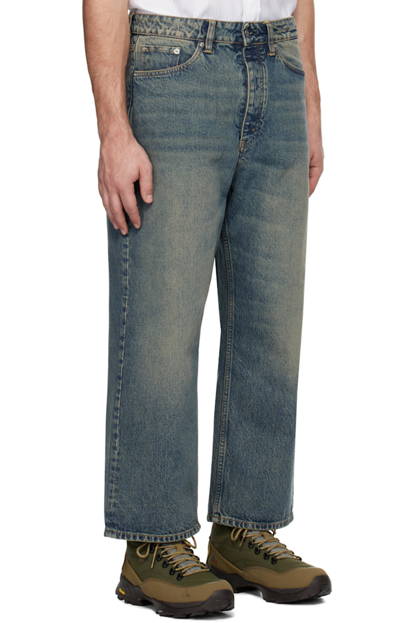 Wide-leg non-stretch regenerative- and organic cotton-blend denim jeans. Fading and whiskering throughout.

· Belt loops
· Five-pocket styling
· Button-fly
· Cropped legs
· Logo patch at back waistband
· Logo-engraved silver-tone hardware

Supplier color: Mid blue dirty
