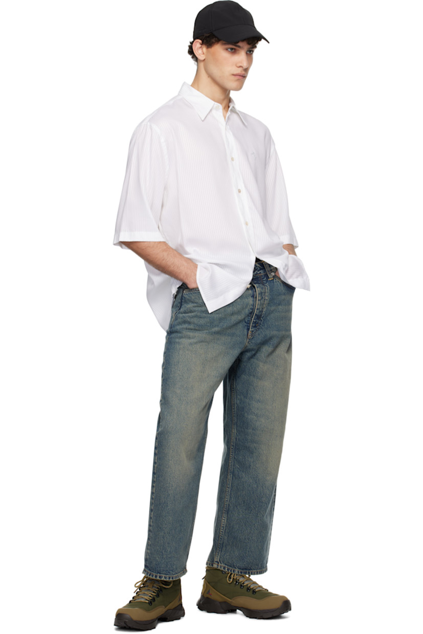 Wide-leg non-stretch regenerative- and organic cotton-blend denim jeans. Fading and whiskering throughout.

· Belt loops
· Five-pocket styling
· Button-fly
· Cropped legs
· Logo patch at back waistband
· Logo-engraved silver-tone hardware

Supplier color: Mid blue dirty