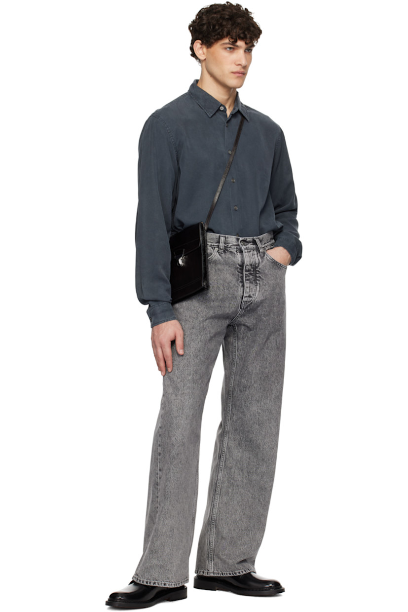 Tencel satin shirt. 

· Spread collar
· Button closure
· Shirttail hem
· Pleated single-button barrel cuffs
· Twin pleats at back yoke

Supplier color: Faded black