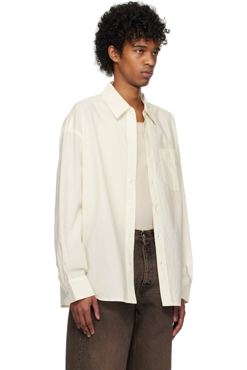 Plain-woven organic cotton- and recycled polyester-blend shirt. 

· GOTS-certified organic cotton
· GRS-certified recycled polyester
· Spread collar
· Button closure
· Patch pocket
· Shirttail hem 
· Dropped shoulders
· Adjustable single-button barrel cuffs
· Box pleat at yoke  
· Mother-of-pearl hardware

Supplier color: Raw white