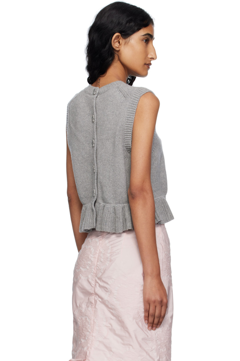 Knit recycled cashmere-blend vest.

· Rib-knit crewneck, hem, and armscyes
· Ruffled peplum hem
· Button closure at back

Supplier color: Grey