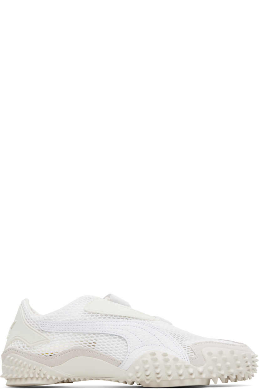 Low-top mesh sneakers in white and gray. 

· Rubberized trim throughout
· Logo patch at offset velcro strap
· Logo patch and concealed elasticized gusset at tongue
· Grained faux-leather Formstrip at outer side
· Logo embossed at heel counter
· Cushioned OrthoLite® footbed
· Faux-suede trim at welt
· Spikes at rubber midsole
· Treaded rubber sole

Supplier color: Puma white/Vapor gray