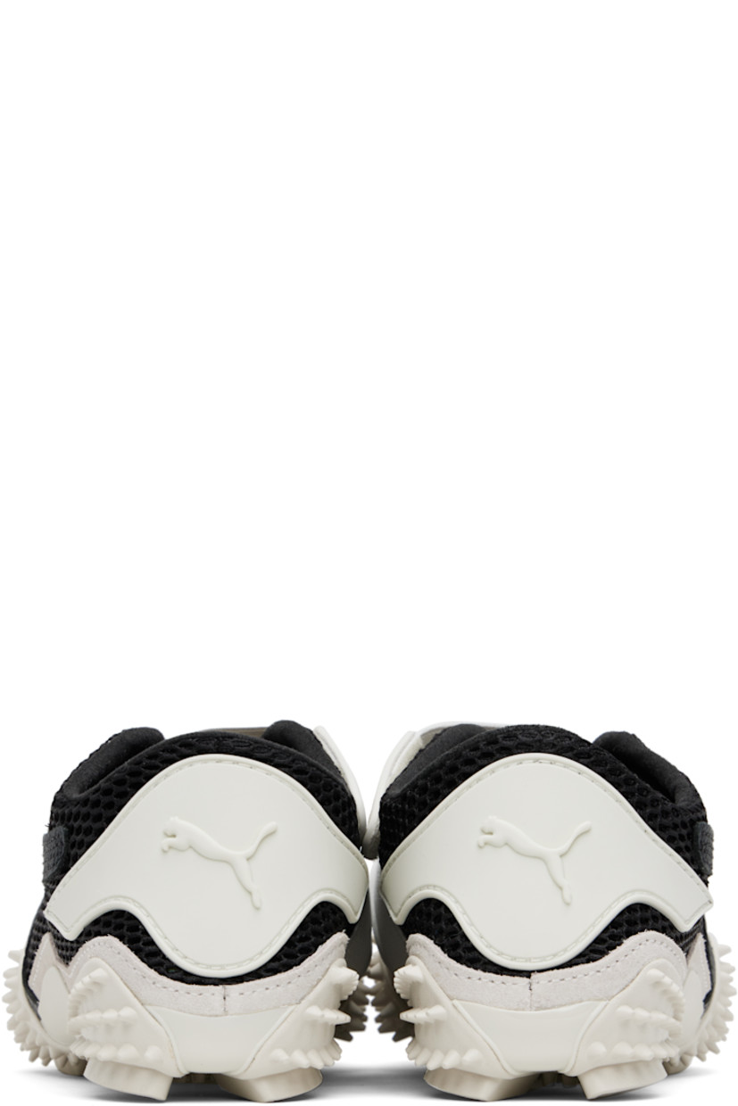 Low-top mesh sneakers in black and gray. 

· Rubberized trim throughout
· Logo patch at offset velcro strap
· Logo patch and concealed elasticized gusset at tongue
· Grained faux-leather Formstrip at outer side
· Logo embossed at heel counter
· Cushioned OrthoLite® footbed
· Faux-suede trim at welt
· Spikes at rubber midsole
· Treaded rubber sole

Supplier color: Vapor gray/Puma black