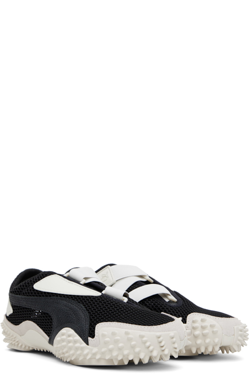 Low-top mesh sneakers in black and gray. 

· Rubberized trim throughout
· Logo patch at offset velcro strap
· Logo patch and concealed elasticized gusset at tongue
· Grained faux-leather Formstrip at outer side
· Logo embossed at heel counter
· Cushioned OrthoLite® footbed
· Faux-suede trim at welt
· Spikes at rubber midsole
· Treaded rubber sole

Supplier color: Vapor gray/Puma black