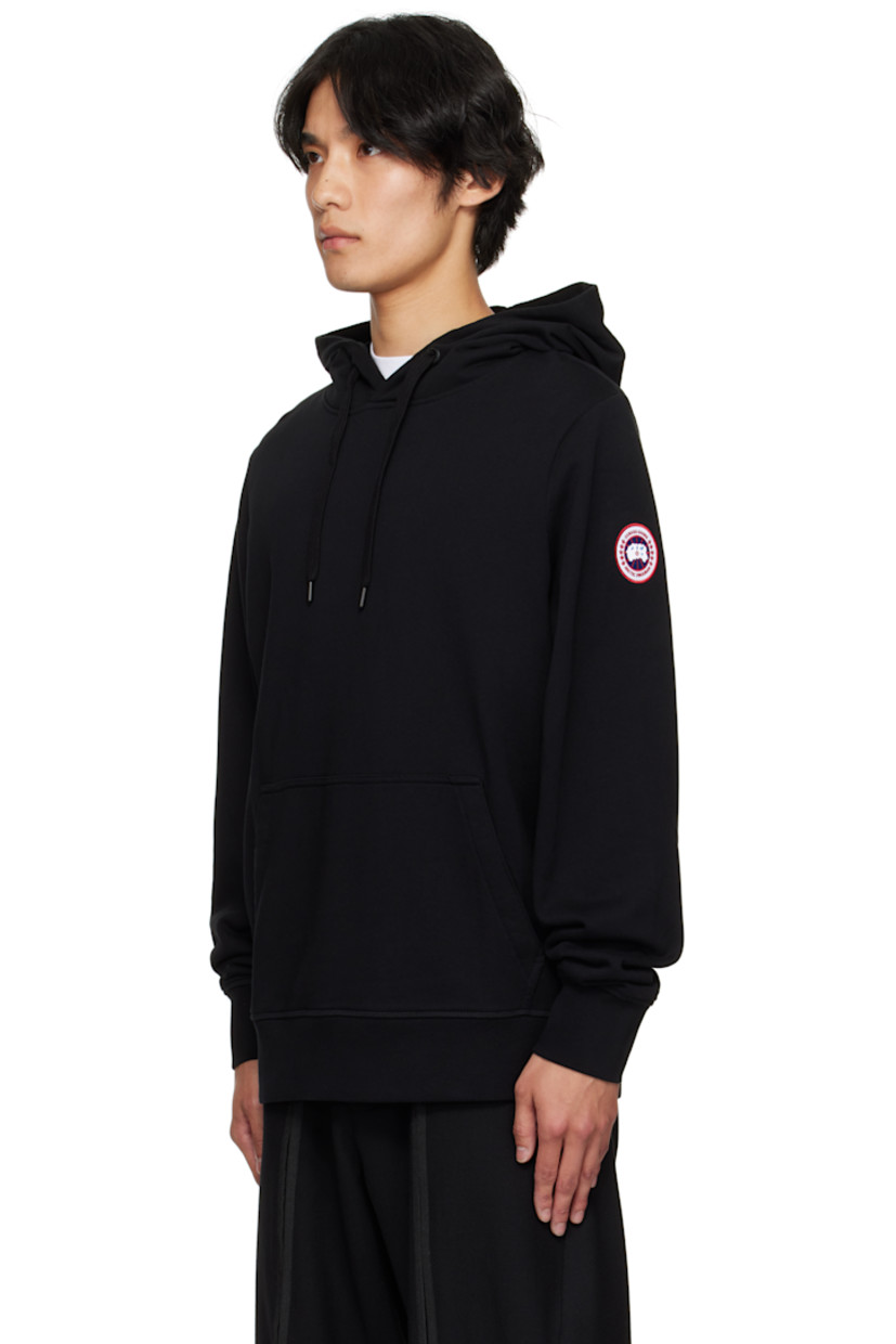 Cotton French terry hoodie.

· Drawstring at hood
· Kangaroo pocket at waist
· Rib-knit hem and cuffs
· Embroidered logo patch at sleeve

Supplier color: Black