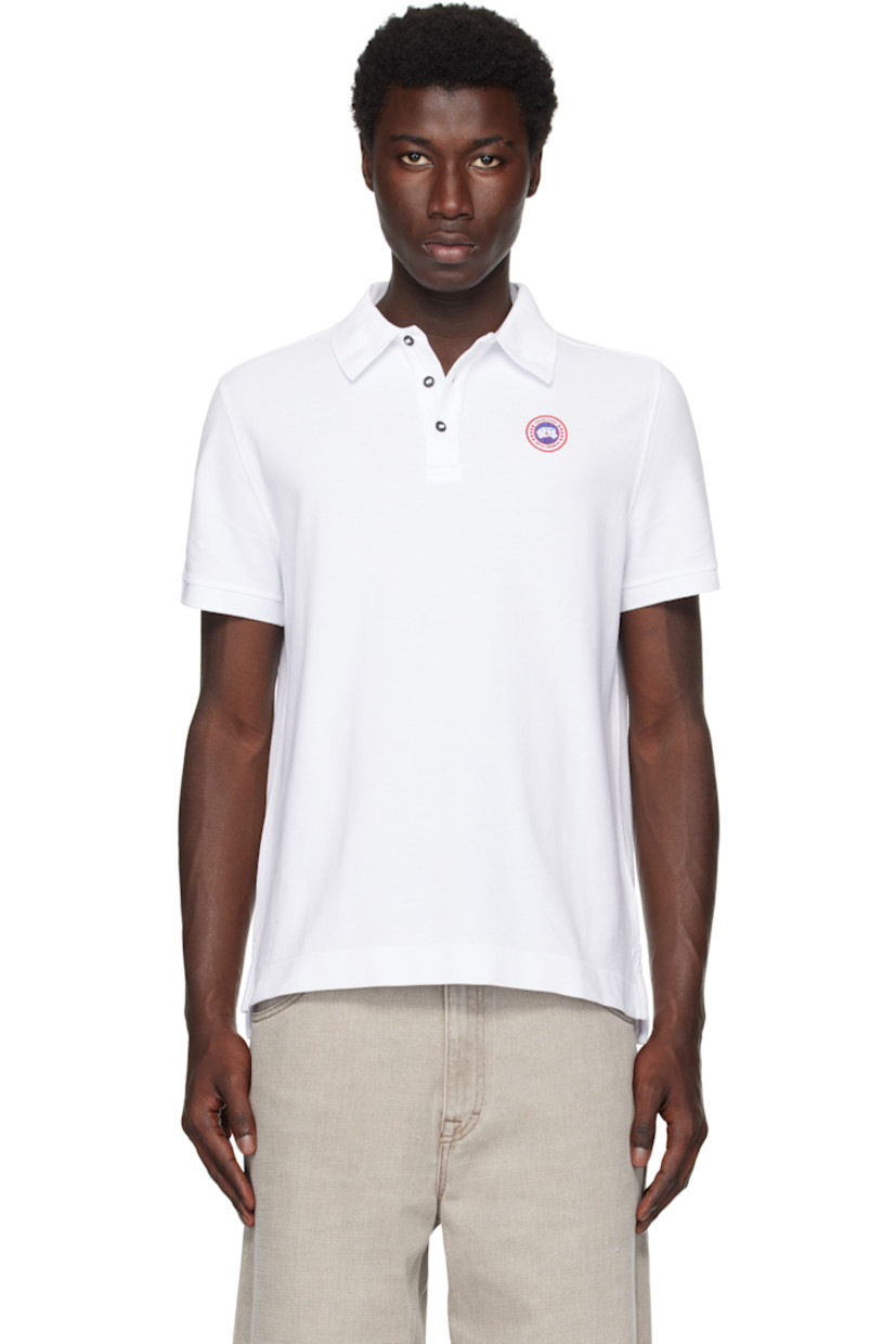 Cotton piqué polo.

· Rib-knit spread collar and cuffs
· Three-button placket
· Embroidered logo patch at chest
· Tennis-tail hem

Supplier color: White