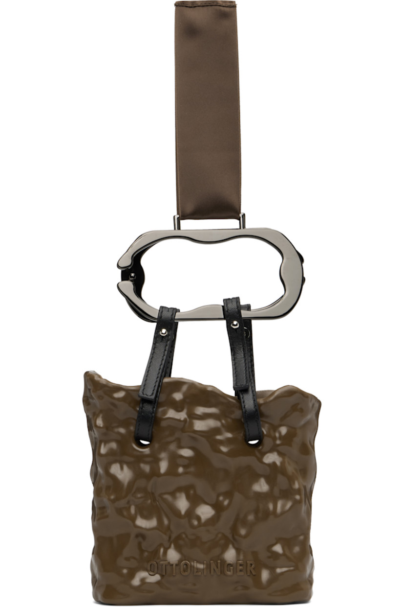 Handcrafted recycled rubber top handle bag.

· Satin ribbon at detachable metal carry handles
· Leather post-stud straps at collar
· Logo embossed at face
· Unlined
· Logo-engraved gunmetal-tone hardware
· H5.5" x W5.75" x D2"

Supplier color: Chocolate