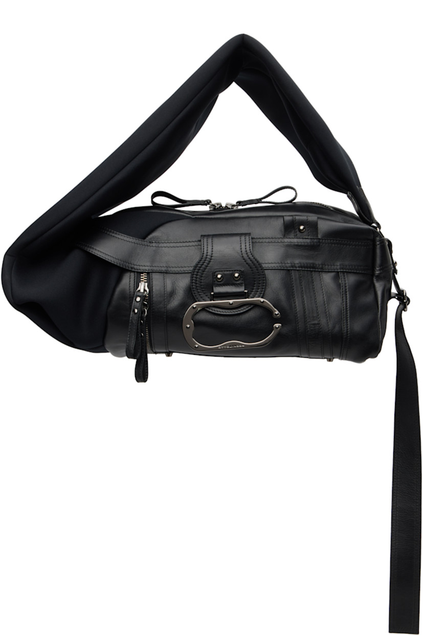 Grained leather and neoprene shoulder bag.

· Adjustable shoulder strap
· Press-stud tab with logo-engraved hardware at face
· Pull-loop at face
· Bumper studs and zip pocket at base
· Twin pull-loops at back face
· Two-way zip closure
· Zip pocket and patch pockets at interior
· Twill lining
· H8.5" x W19" x D10"

Supplier color: Black