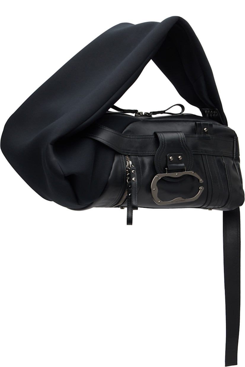 Grained leather and neoprene shoulder bag.

· Adjustable shoulder strap
· Press-stud tab with logo-engraved hardware at face
· Pull-loop at face
· Bumper studs and zip pocket at base
· Twin pull-loops at back face
· Two-way zip closure
· Zip pocket and patch pockets at interior
· Twill lining
· H8.5" x W19" x D10"

Supplier color: Black