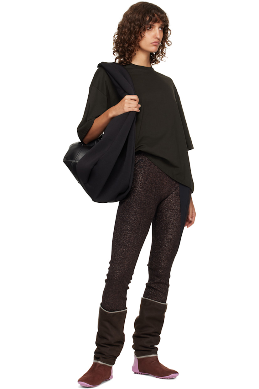 Grained leather and neoprene shoulder bag.

· Adjustable shoulder strap
· Press-stud tab with logo-engraved hardware at face
· Pull-loop at face
· Bumper studs and zip pocket at base
· Twin pull-loops at back face
· Two-way zip closure
· Zip pocket and patch pockets at interior
· Twill lining
· H8.5" x W19" x D10"

Supplier color: Black