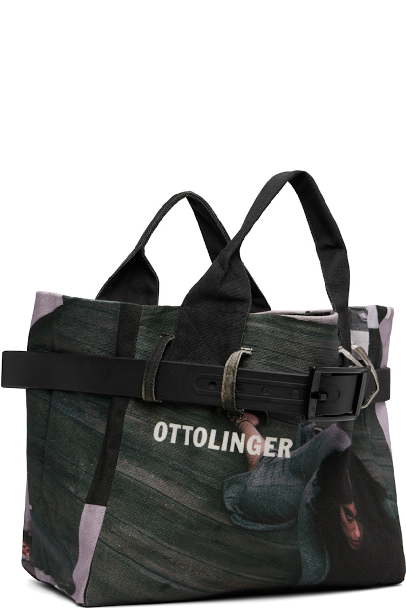Cotton canvas tote.

· Graphics printed throughout
· Fixed twin carry handles
· Wraparound faux-leather pin-buckle strap
· Open throat
· Satin lining
· H10.25" x W12.5" x D7"

Supplier color: Heji