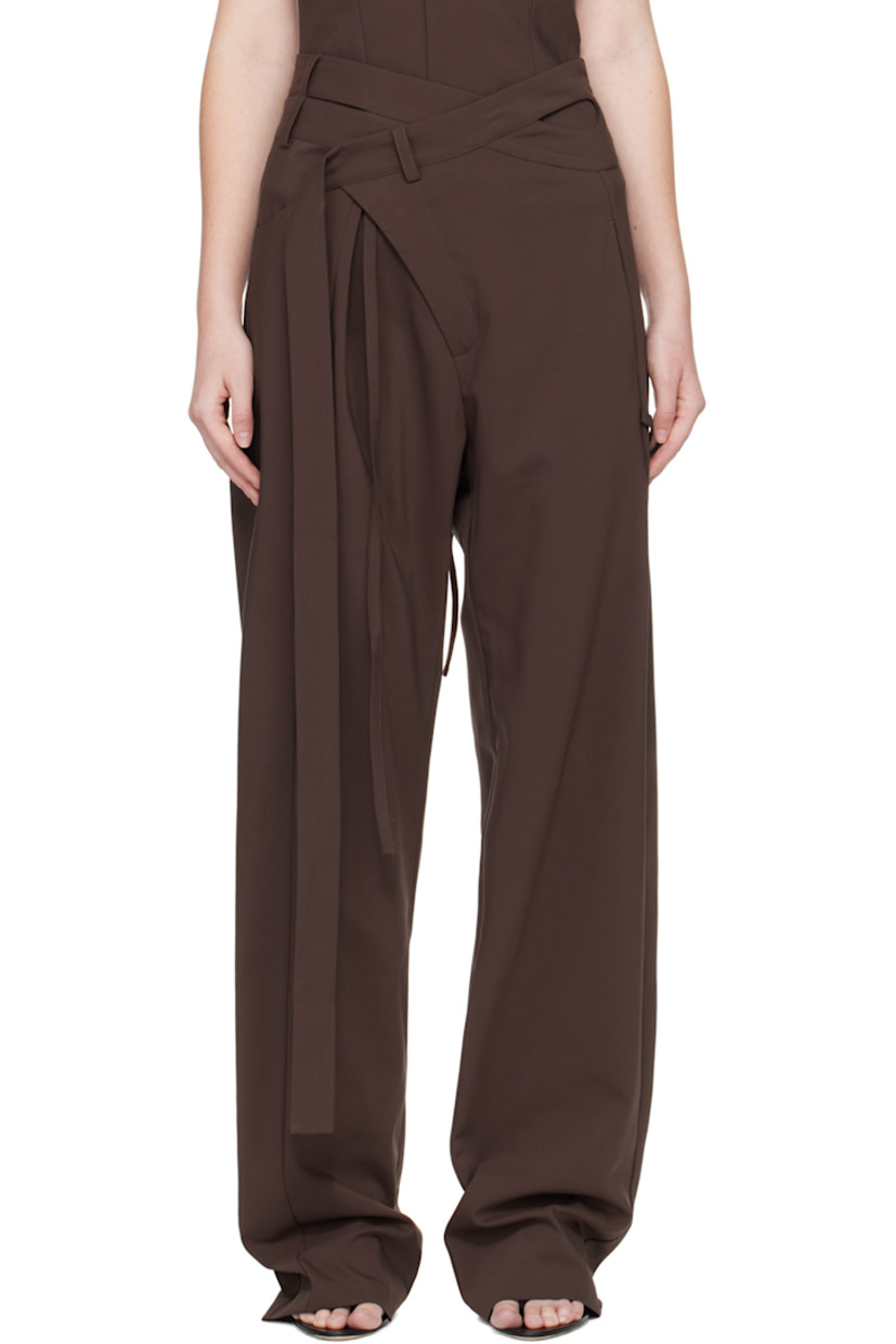 Plain-woven stretch cotton-blend trousers.

· Asymmetrical and wrap construction 
· Belt loops and wraparound straps at waistband
· Three-pocket styling
· Zip fly 
· Strap at outseam 
· Pleat at front 

Supplier color: Dark brown