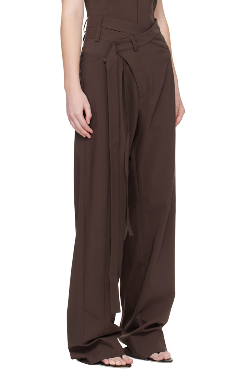 Plain-woven stretch cotton-blend trousers.

· Asymmetrical and wrap construction 
· Belt loops and wraparound straps at waistband
· Three-pocket styling
· Zip fly 
· Strap at outseam 
· Pleat at front 

Supplier color: Dark brown