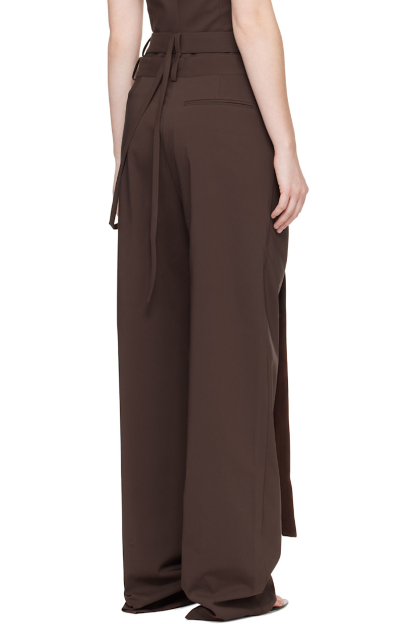 Plain-woven stretch cotton-blend trousers.

· Asymmetrical and wrap construction 
· Belt loops and wraparound straps at waistband
· Three-pocket styling
· Zip fly 
· Strap at outseam 
· Pleat at front 

Supplier color: Dark brown