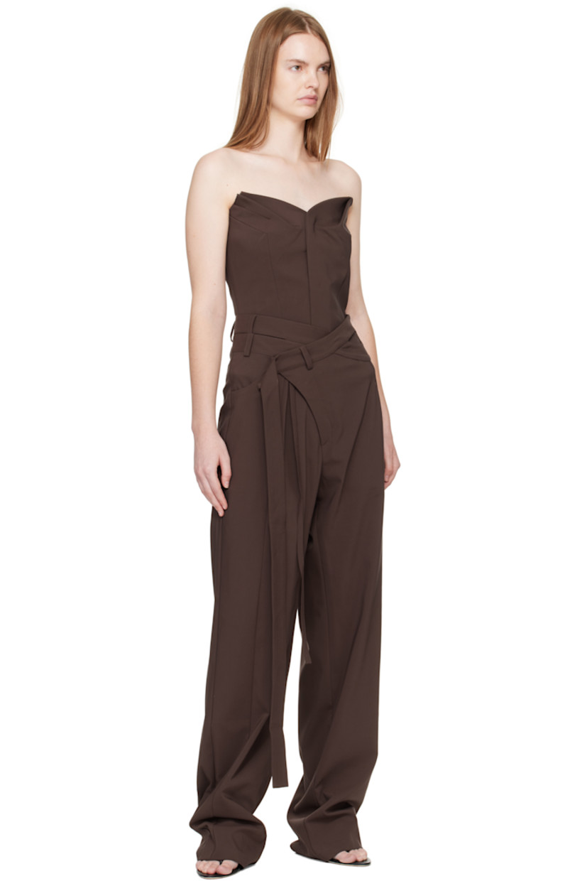 Plain-woven stretch cotton-blend trousers.

· Asymmetrical and wrap construction 
· Belt loops and wraparound straps at waistband
· Three-pocket styling
· Zip fly 
· Strap at outseam 
· Pleat at front 

Supplier color: Dark brown