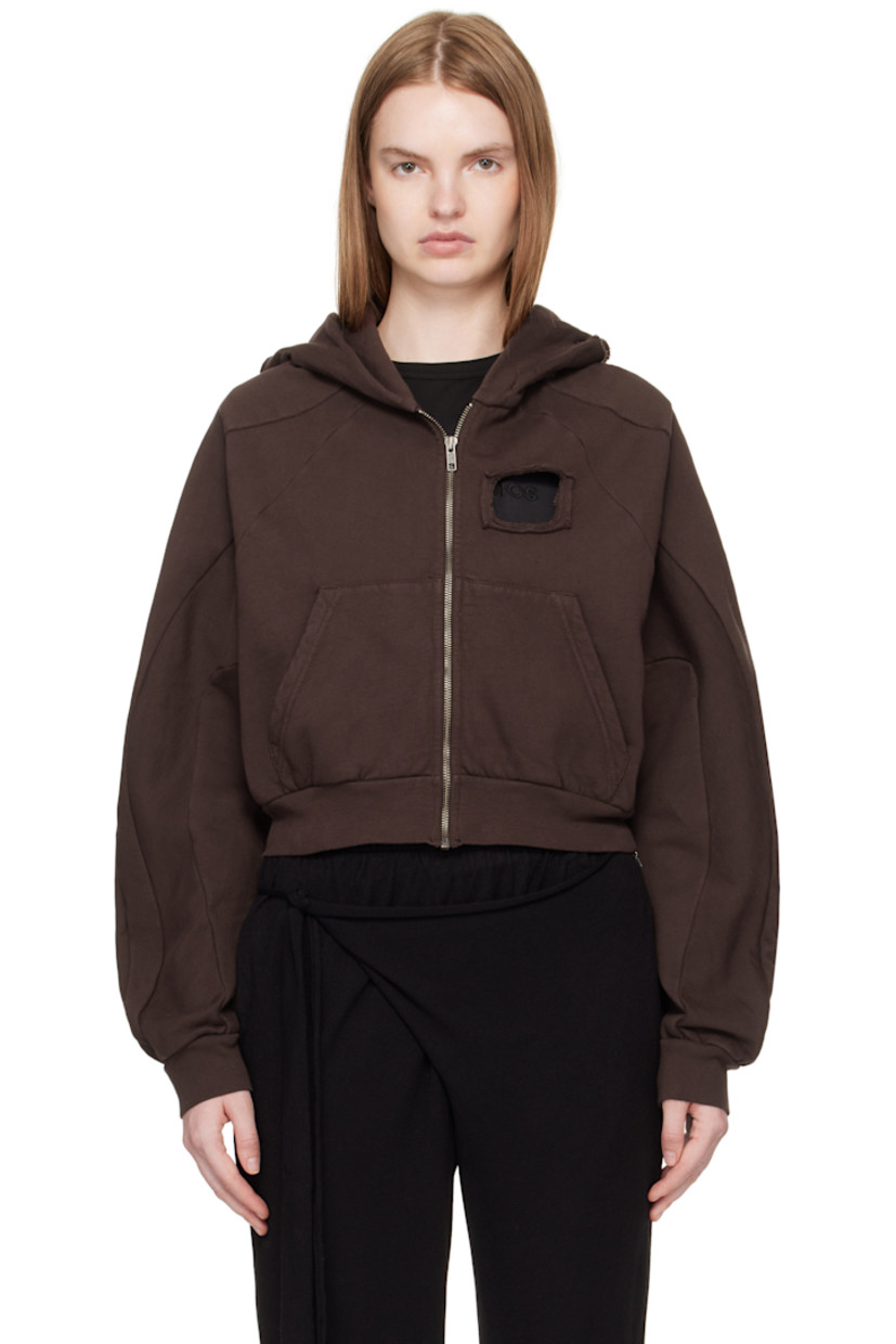 Organic cotton fleece hoodie. 

· Cutouts, distressing, and raw edges throughout 
· Zip closure
· Patch pockets at waist
· Raglan sleeves
· Rib-knit hem and cuffs
· Cropped hem 

Supplier color: Dark brown wash