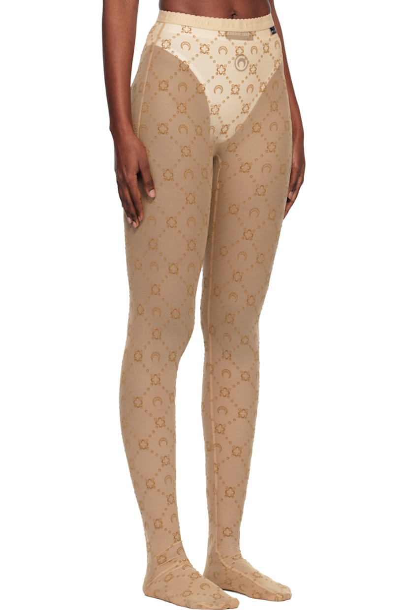 Sheer stretch recycled nylon mesh tights.

· Logo pattern flocked throughout
· High-rise
· Scalloped edge at logo-woven elasticized waistband
· Logo flag at front

Supplier color: Moonogram flock mesh camel