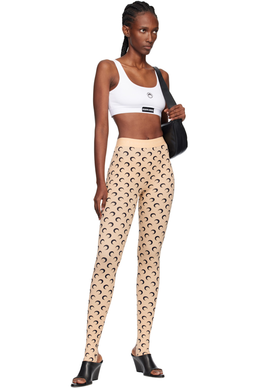 Stretch recycled nylon jersey leggings.

· Logo pattern printed throughout
· Logo-woven elasticized waistband
· Stirrup at cuffs

Supplier color: Moon black on tan