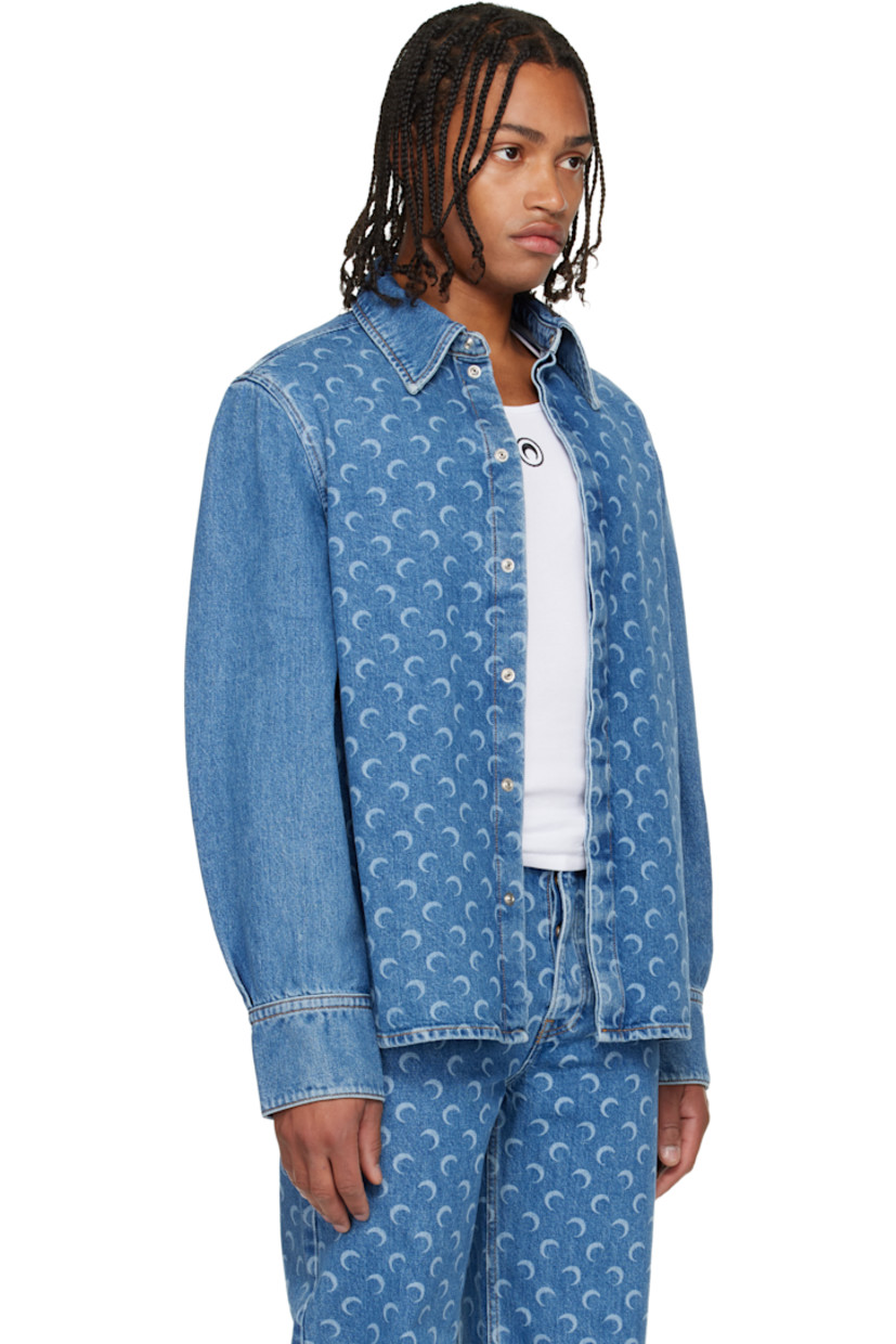Non-stretch denim shirt. 

· Laser-printed logo pattern throughout 
· Spread collar
· Concealed press-stud closure
· Shirttail hem
· Buttoned barrel cuffs
· Logo patch at back collar
· Contrast stitching in tan

Supplier color: Light blue