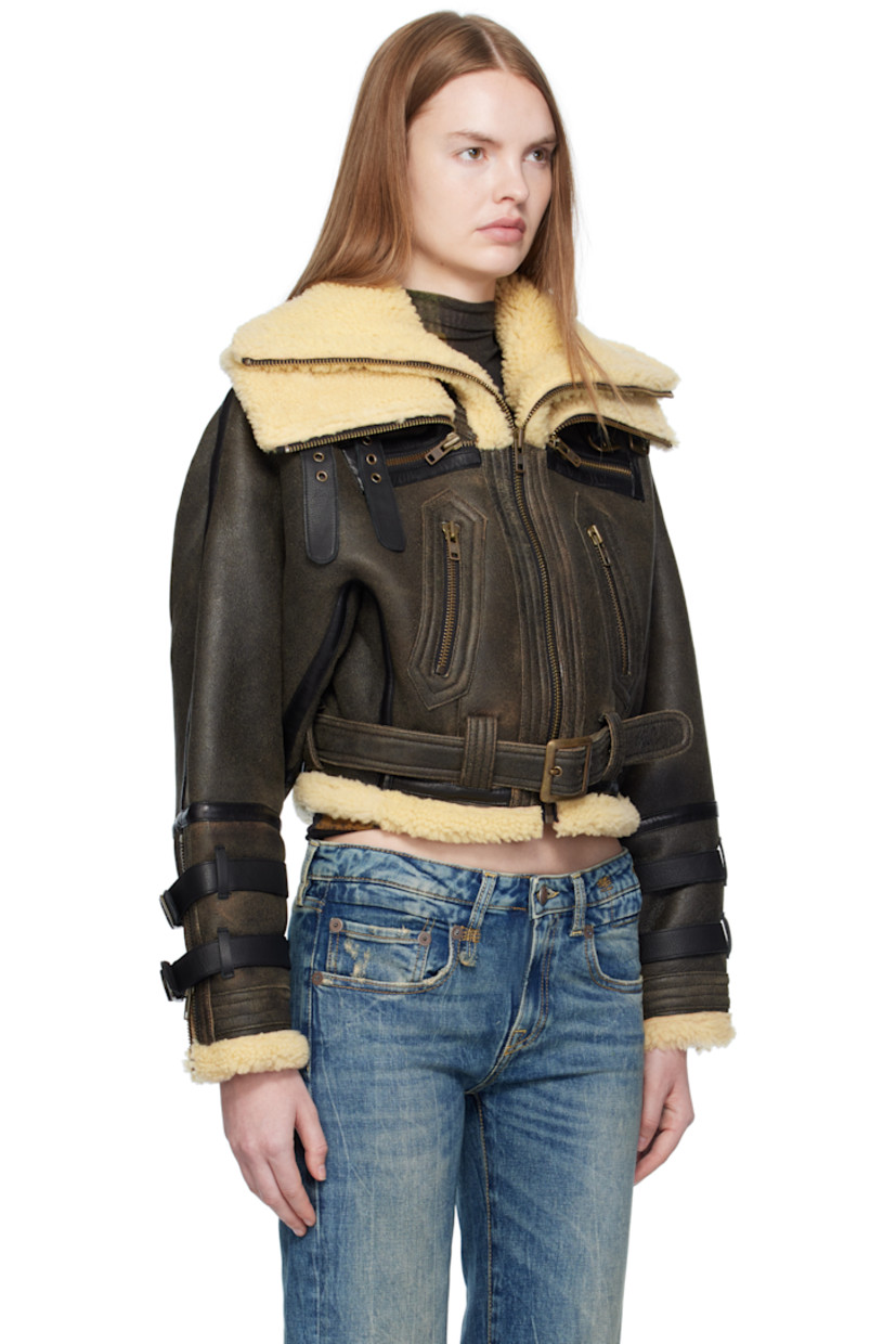 Dyed shearling jacket. 

· Layered funnel necks
· Pin-buckle straps at collar and cuffs
· Zip closure
· Zip pockets at waist
· Cropped hem
· Belt loops and detachable pin-buckle belt at hem
· Zip vent at cuffs

Supplier color: Black with cream